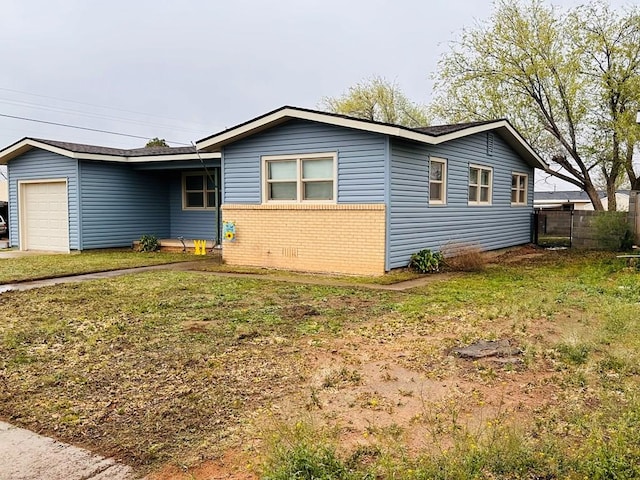 301 SW 11th St, Andrews, TX 79714 - view of front facade with a garage and brick siding