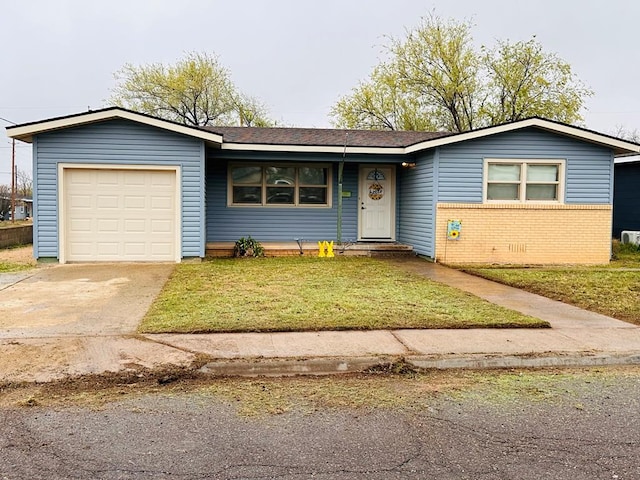 301 SW 11th St, Andrews, TX 79714 - ranch-style home featuring a garage, a front yard, driveway, and brick siding