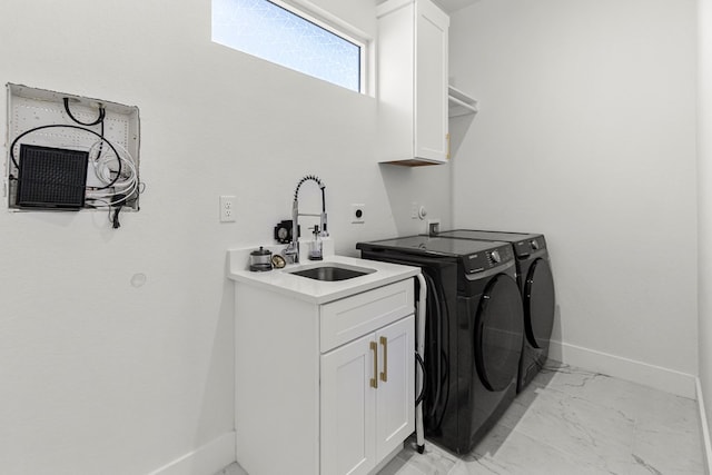 8652 Fiesta Ct, Odessa, TX 79765 - laundry room featuring cabinet space, light marble finish floors, and washer and dryer