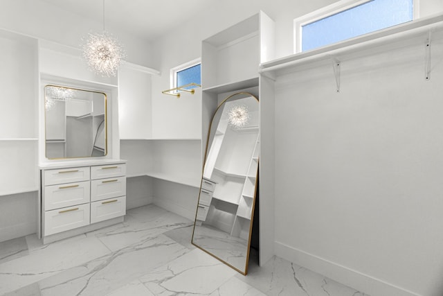 8652 Fiesta Ct, Odessa, TX 79765 - walk in closet with light marble finish floors and a chandelier