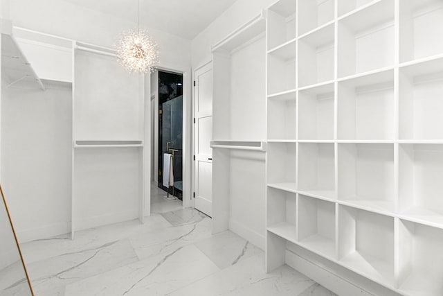 8652 Fiesta Ct, Odessa, TX 79765 - spacious closet featuring marble look tiles and a chandelier