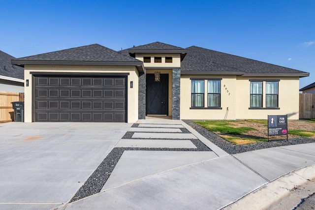 8652 Fiesta Ct, Odessa, TX 79765 - prairie-style house featuring stucco siding, concrete driveway, an attached garage, and roof with shingles