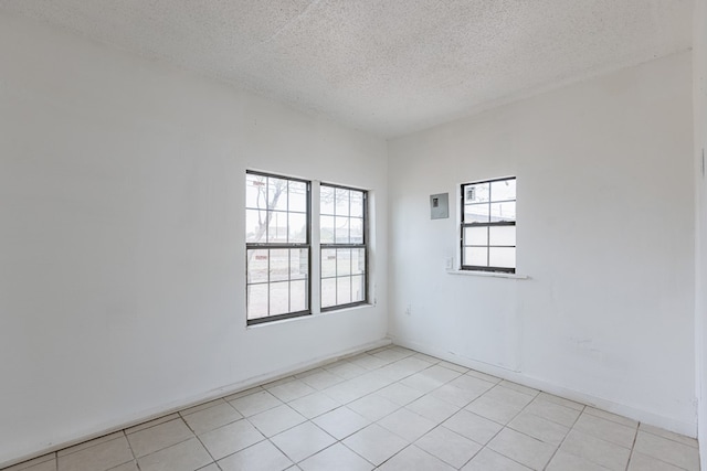 900 N Dotsy Ave, Odessa, TX 79763 - unfurnished room with a textured ceiling and light tile patterned flooring