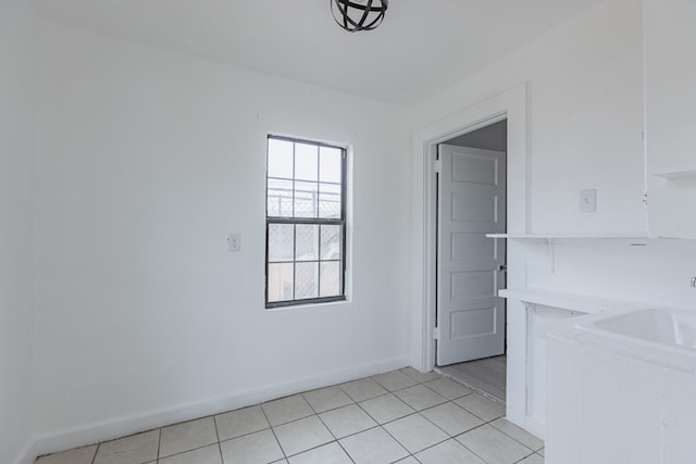 900 N Dotsy Ave, Odessa, TX 79763 - unfurnished dining area with baseboards and light tile patterned flooring