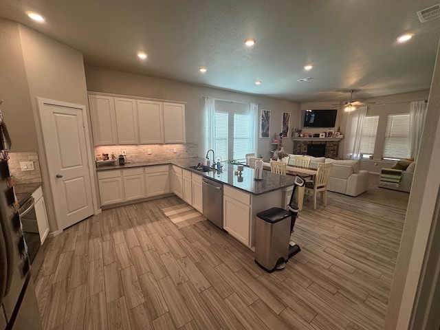 2405 Rio, Midland, TX 79705 - kitchen with stainless steel dishwasher, a ceiling fan, a peninsula, tasteful backsplash, and recessed lighting