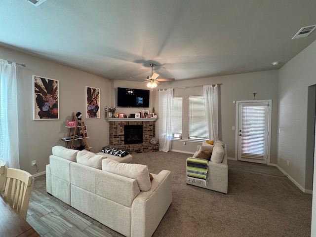 2405 Rio, Midland, TX 79705 - living room with a brick fireplace, ceiling fan, and carpet flooring