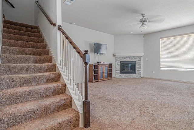 1506 San Miguel Ct, Midland, TX 79705 - stairway with ceiling fan, carpet floors, and a fireplace