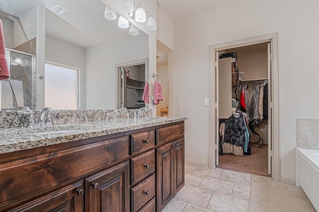 1506 San Miguel Ct, Midland, TX 79705 - bathroom with a walk in closet, double vanity, a stall shower, and a bath