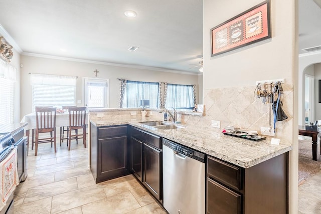 kitchen with dishwasher, light stone counters, kitchen peninsula, and sink