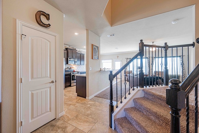 staircase with a textured ceiling