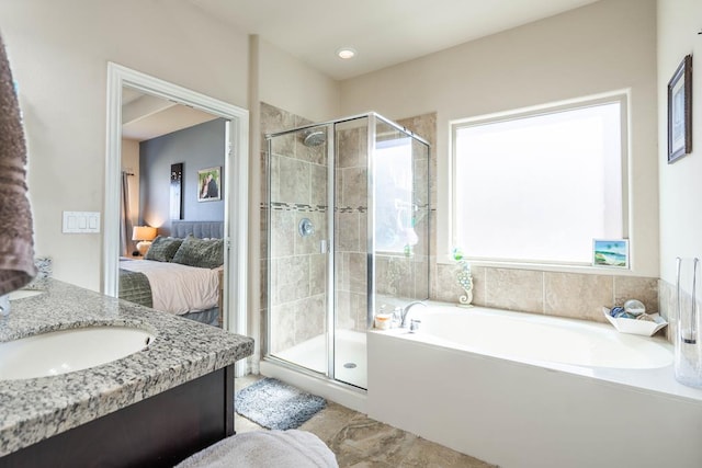 bathroom with vanity and separate shower and tub