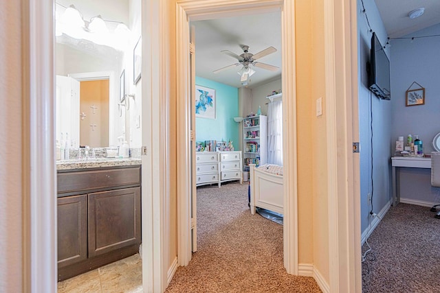 hallway featuring light colored carpet