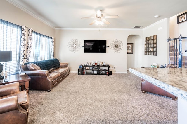 living room with carpet floors, ceiling fan, and crown molding