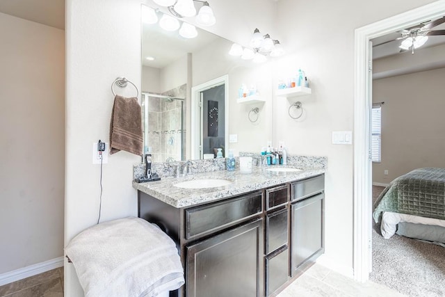 bathroom with ceiling fan, tile patterned flooring, vanity, and walk in shower