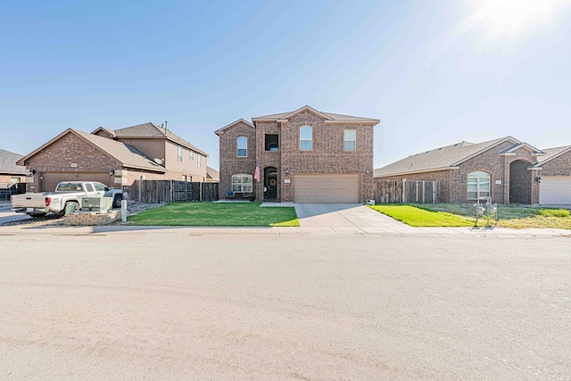 view of property with a garage and a front lawn