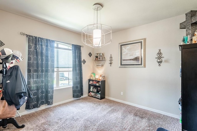 miscellaneous room featuring carpet floors and a chandelier