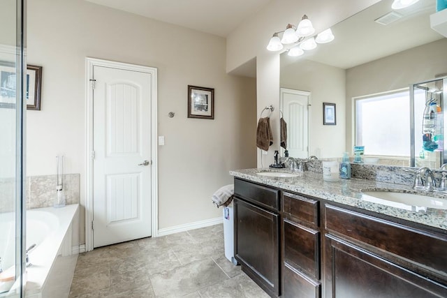 bathroom with vanity and tiled bath