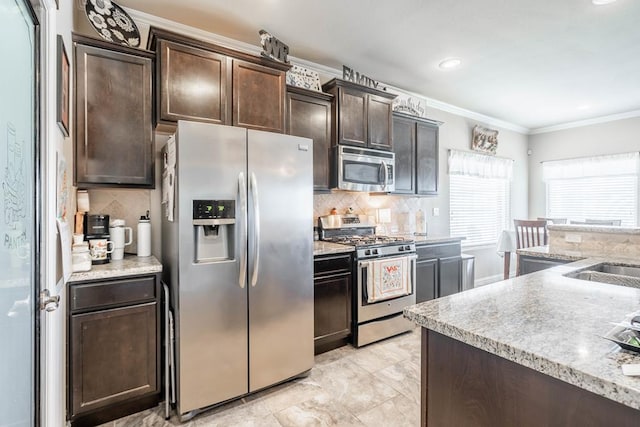 kitchen with backsplash, dark brown cabinetry, ornamental molding, and appliances with stainless steel finishes