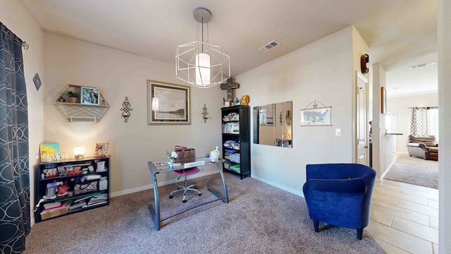 office area featuring carpet flooring and an inviting chandelier