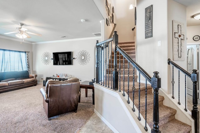 living room featuring carpet flooring, ceiling fan, and ornamental molding