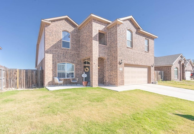 view of front of home featuring a patio area, a front lawn, and a garage