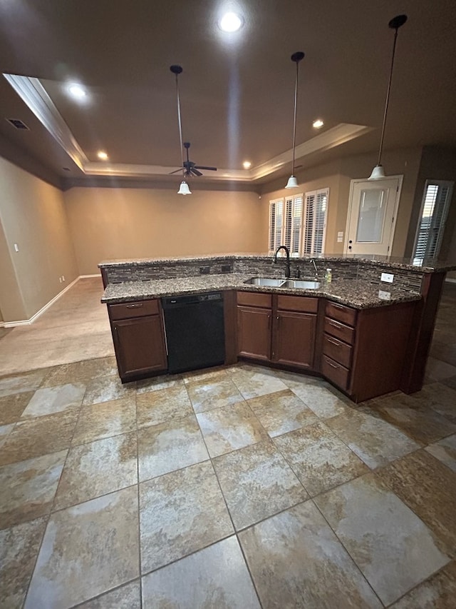 kitchen featuring ceiling fan, sink, black dishwasher, a raised ceiling, and pendant lighting