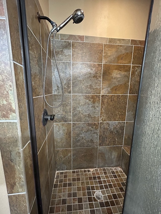 bathroom with tiled shower