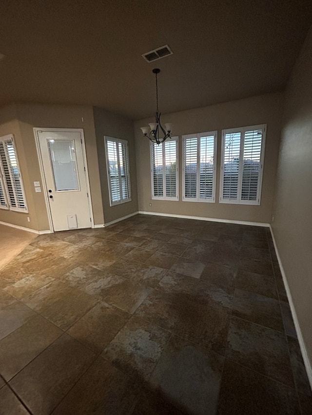 unfurnished dining area with a chandelier