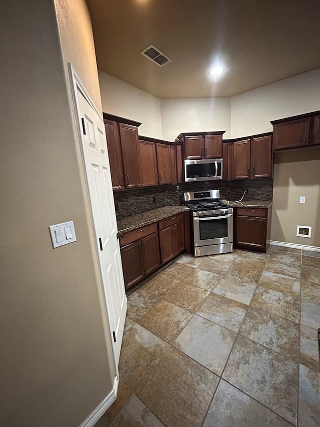 kitchen featuring appliances with stainless steel finishes, dark brown cabinetry, and tasteful backsplash