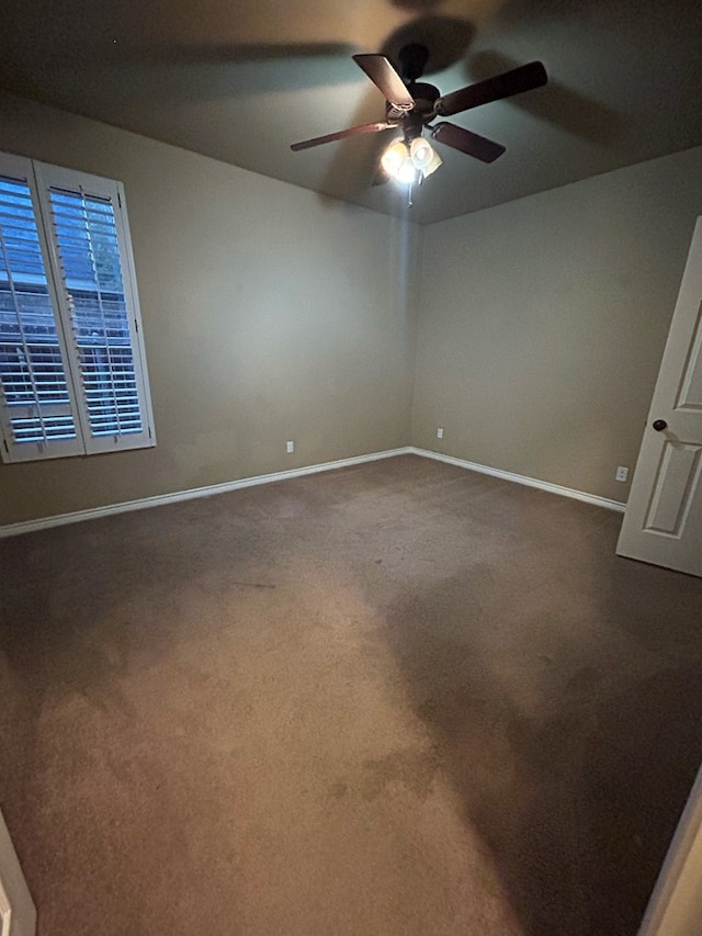 spare room with ceiling fan and carpet floors