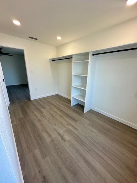 unfurnished bedroom with hardwood / wood-style flooring and a closet