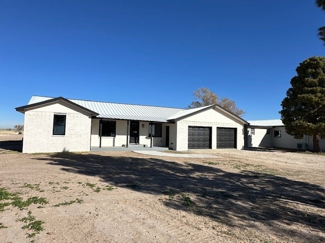 view of front of home with covered porch and a garage