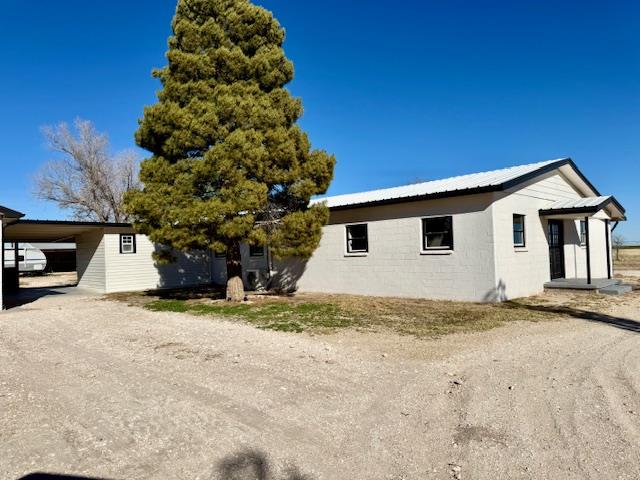 view of home's exterior with a carport