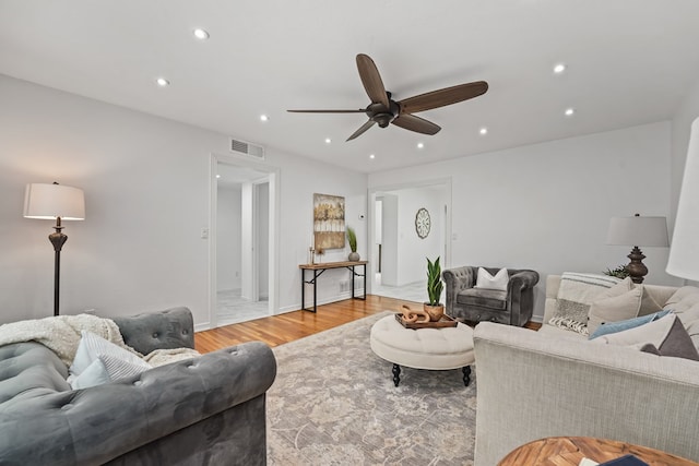 living area featuring ceiling fan, recessed lighting, light wood-style flooring, and baseboards