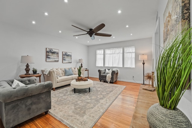 living room featuring a ceiling fan, recessed lighting, light wood-style flooring, and baseboards