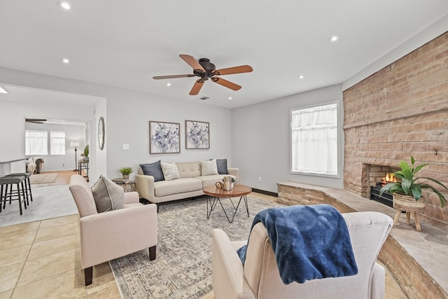 tiled living area featuring recessed lighting, ceiling fan, and a fireplace
