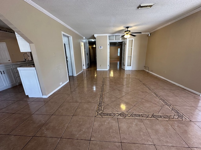 902 W 39th St, Odessa, TX 79764 - empty room featuring ornamental molding, a ceiling fan, a textured ceiling, and tile patterned flooring