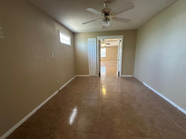 902 W 39th St, Odessa, TX 79764 - tiled empty room featuring ceiling fan and a textured ceiling