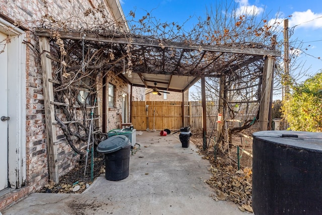 view of patio with a ceiling fan and fence