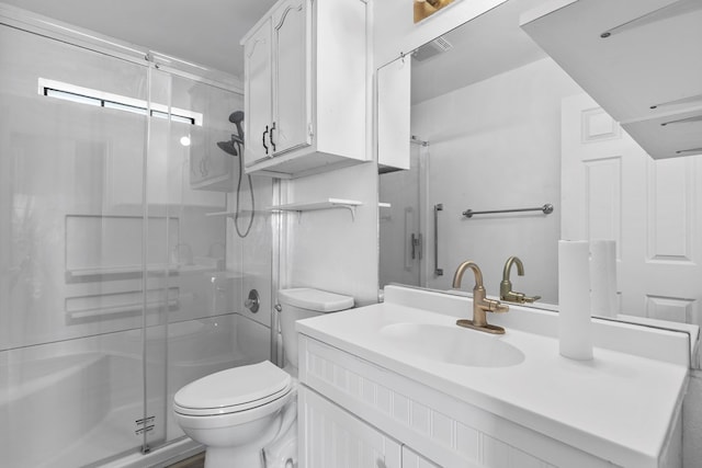 bathroom with a stall shower, vanity, and toilet