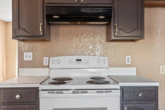 kitchen featuring dark brown cabinetry, white electric range oven, ventilation hood, and light countertops