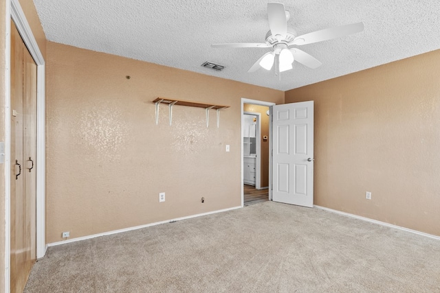 unfurnished bedroom with light carpet, baseboards, visible vents, and a textured ceiling