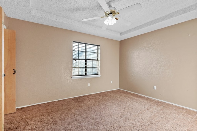 carpeted empty room with ceiling fan, a textured ceiling, and a textured wall