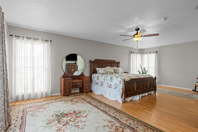 9408 Cromwell Ter, Odessa, TX 79764 - bedroom featuring ceiling fan, baseboards, and wood finished floors