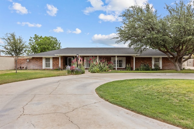 9408 Cromwell Ter, Odessa, TX 79764 - single story home with curved driveway, a front lawn, and brick siding