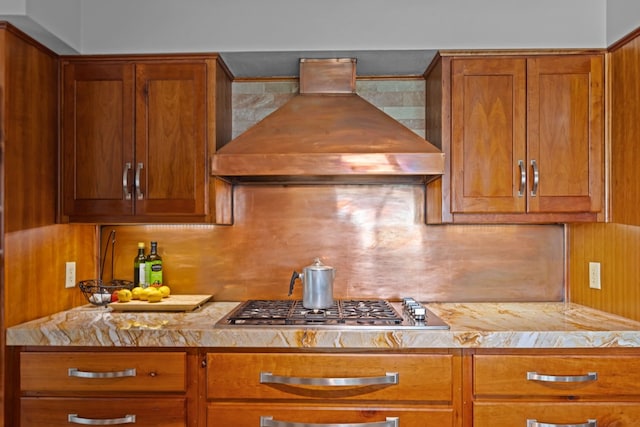 9408 Cromwell Ter, Odessa, TX 79764 - kitchen with brown cabinetry, custom exhaust hood, and stainless steel gas cooktop