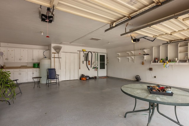 9408 Cromwell Ter, Odessa, TX 79764 - garage with gas water heater, visible vents, and a garage door opener