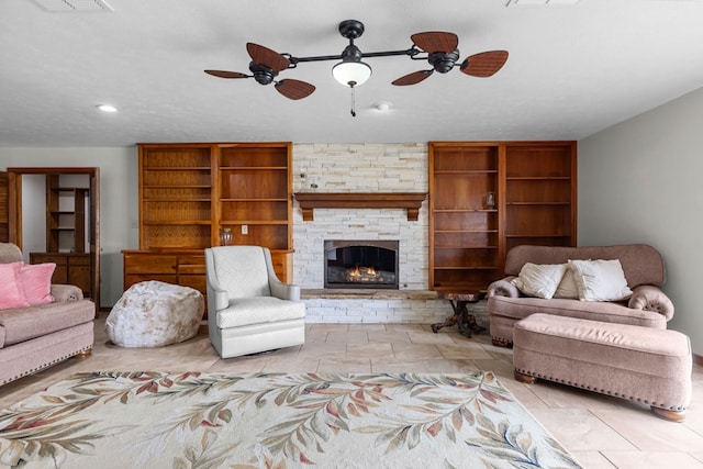 9408 Cromwell Ter, Odessa, TX 79764 - living room featuring ceiling fan, a stone fireplace, visible vents, and recessed lighting