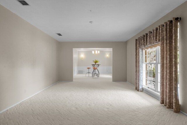 9408 Cromwell Ter, Odessa, TX 79764 - empty room featuring carpet, visible vents, baseboards, and a notable chandelier