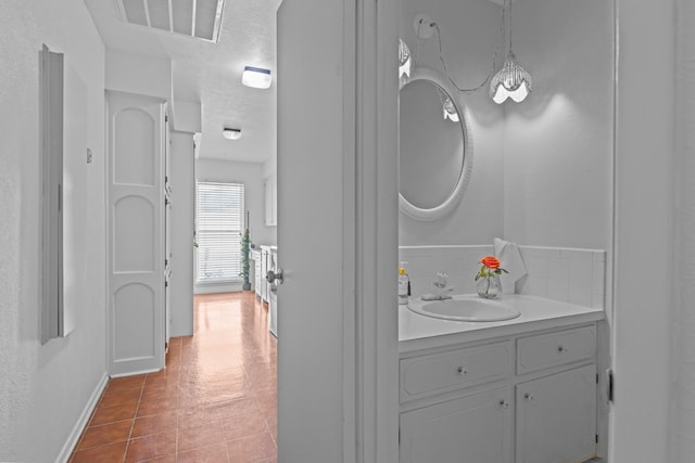 9408 Cromwell Ter, Odessa, TX 79764 - bathroom featuring baseboards, vanity, and visible vents